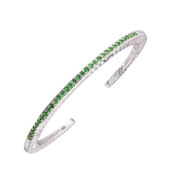 WhiteSS Shooting Stars Narrow Staking Cuff Bracelet STONES: Greene Tourmaline, Medium

Solid, narrow (3mm) cuff bracelet; pierced with signature interlocking spirals. This cuff is available in sterling silver with 11 or 33 (2ct) - 1.7 mmr green tourmalines. The cuff is designed to fit tightly on the wrist (because with this design, you shouldn’t manually squeeze tighten the cuff). Size Medium

The opening at the bottom of the cuff is just over 3/4’ but the spring hinge makes it easy to put on and easy to take off.