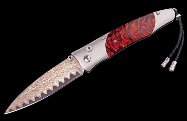 The Gentac ‘Red Sun' features a light and resilient frame in aerospace grade titanium, inlaid with stabilized Blue Spruce Pine Cone. The blade is 'Copper Wave' damascus with a core of VG5 steel; the one-hand button lock and the thumb stud are set with spinel. An exceptional design that offers rigorous performance in a sleek, comfortable knife, the Gentac is also the perfect canvas to showcase William Henry’s range of exotic materials and techniques. The 'Red Sun’ features some of the hi-tech materials and hand-forged metals that are the hallmark of William Henry's collections; a modern design for a timeless heirloom to be proudly worn and used for a lifetime before being handed-down to another generation.
FEATURES & SPECS
One-hand button lock system
Shipped in an elegant wood presentation box
Dimensions: 
Blade 3.25" (82.5mm)
Handle 3.80" (96.5mm)
Overall open 7.00" (177.8mm)